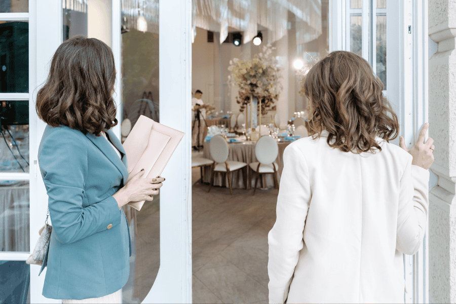 Eventmanagerin bei der Umsetzung des Evens mit Kollegin vor Location